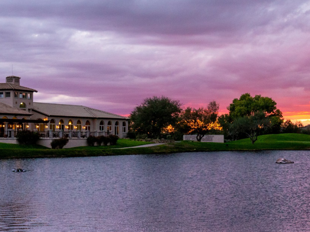 Arizona National clubhouse on lake with sunset