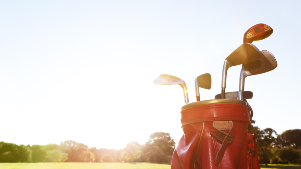 golf clubs in bag on golf course with sunshine