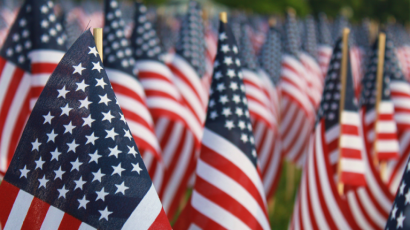 Small American Flags lined up in grass