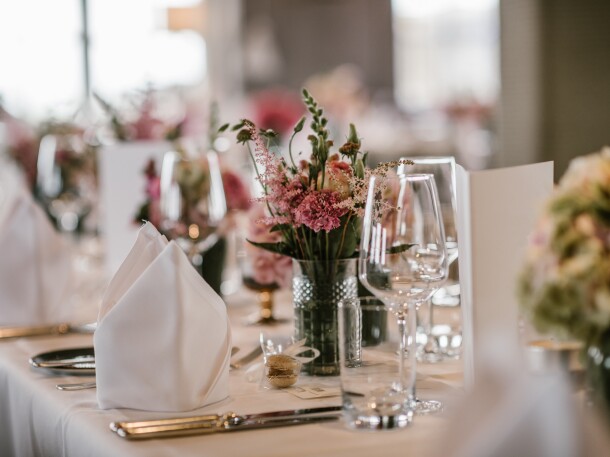 Banquet Event Table Set Up - flowers napkins glasses table setting
