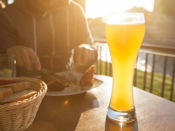 sunset meal with tall beer in sunlight