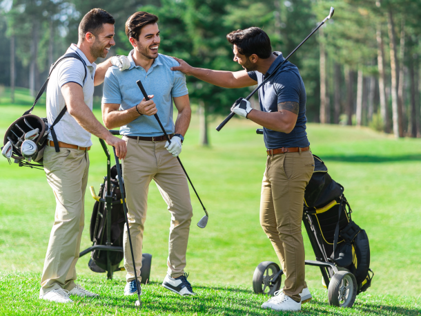 threesome of golfer guys holding clubs