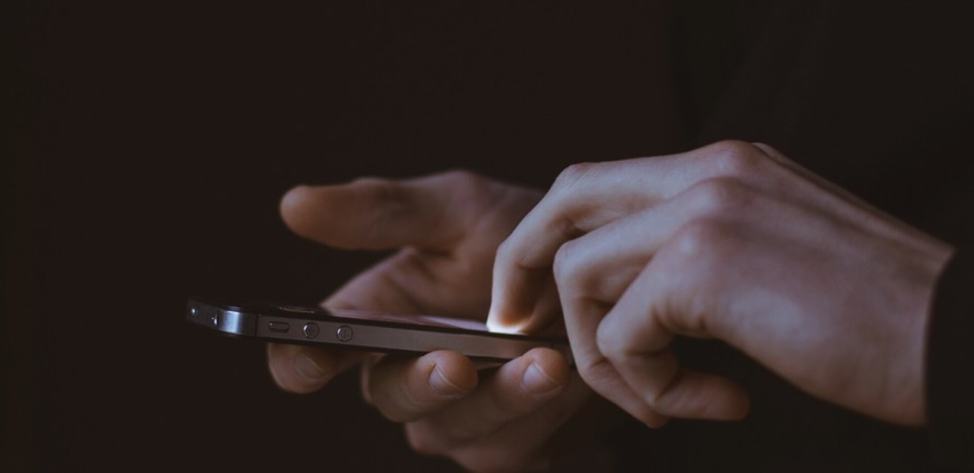 Hands using an App or texting on mobile phone