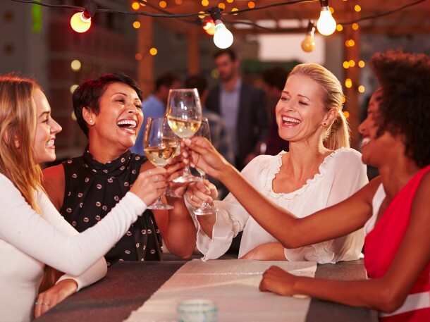 ladies cheers wine at restaurant