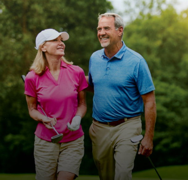 senior couple coed golfers on course