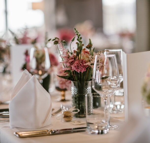 Banquet Event Table Set Up - flowers napkins glasses table setting