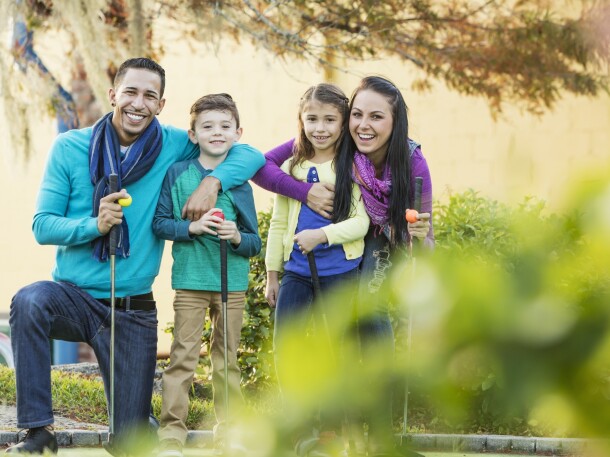 Family playing on golf course