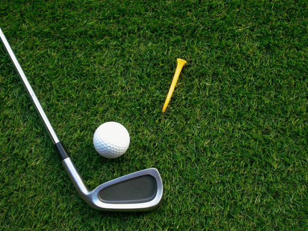 golf club, ball and tee laying on grass