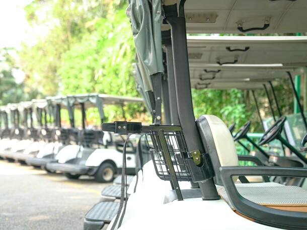 Golf carts parked outside a golf club