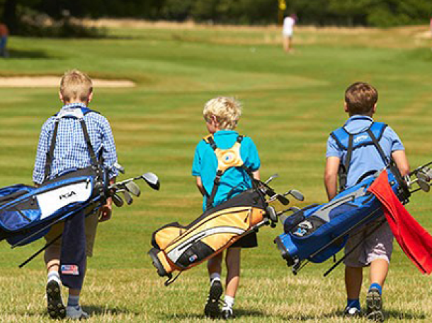 junior golfers walking golf course