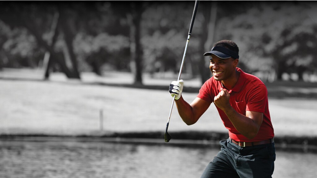 golfer celebrating shot with club in hand