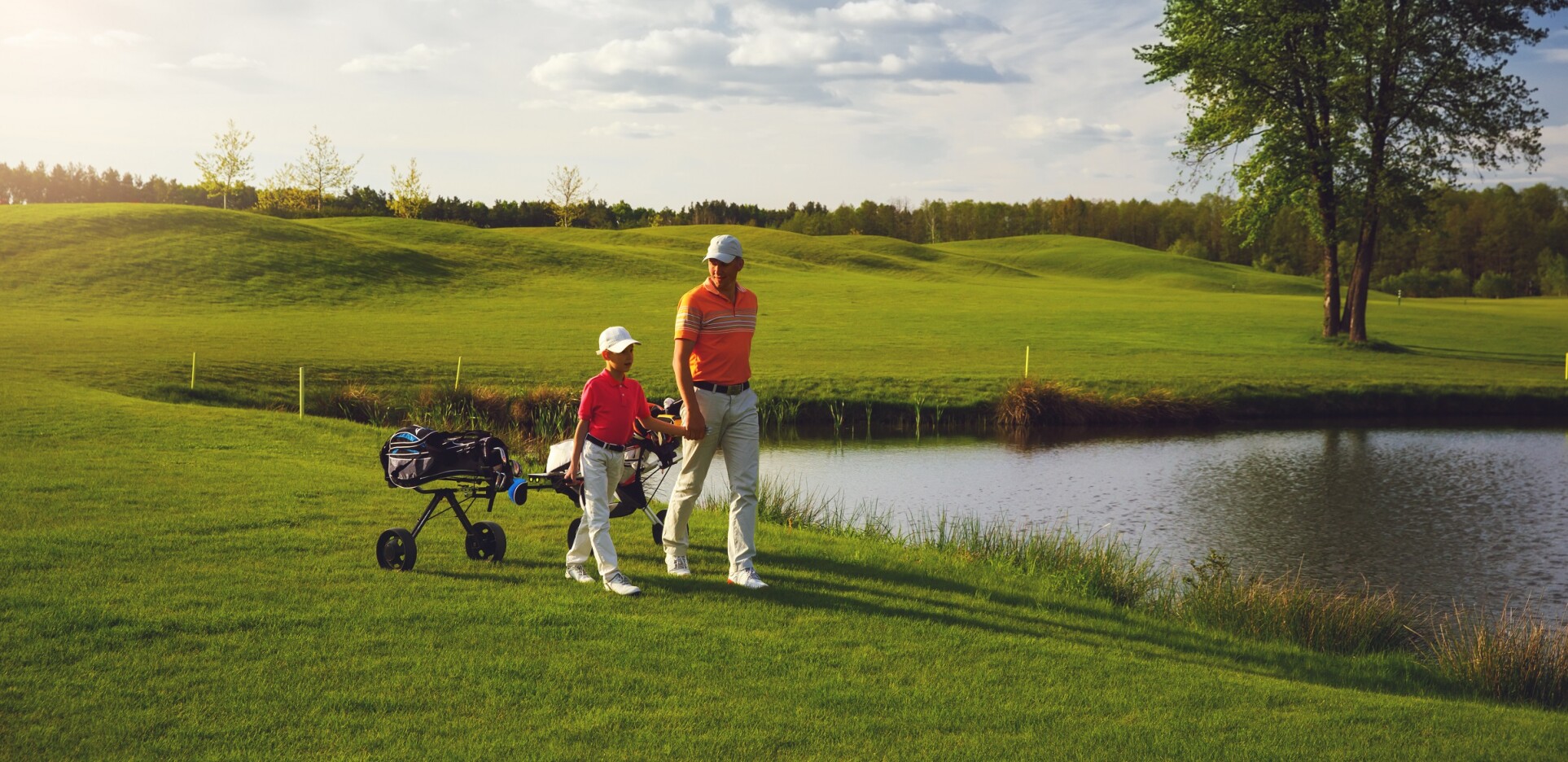 father son on course by pond