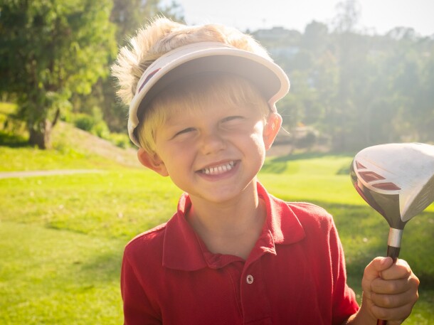 Junior Golfer Smiling on the golf course