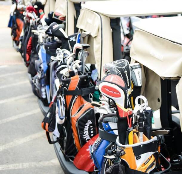 golf carts lined up for golf outing or tournament on the course