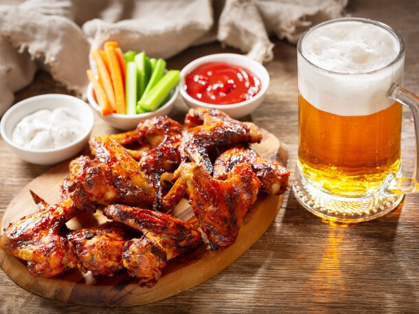 plate of grilled chicken wings and mug of beer