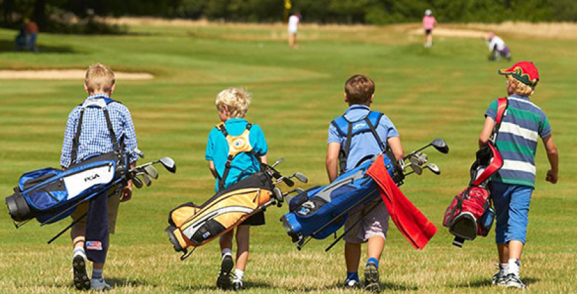junior golfers walking golf course