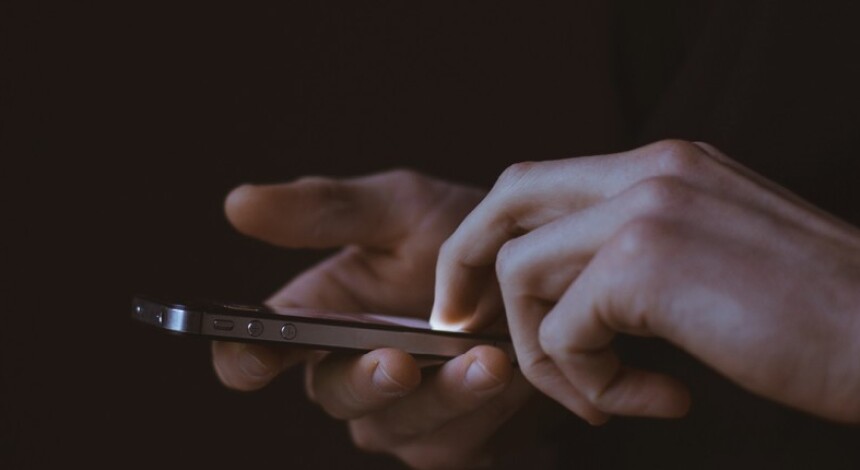 Hands using an App or texting on mobile phone