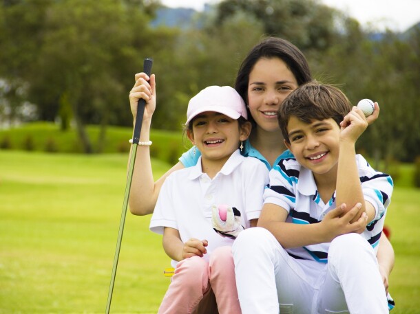 Family playing on golf course