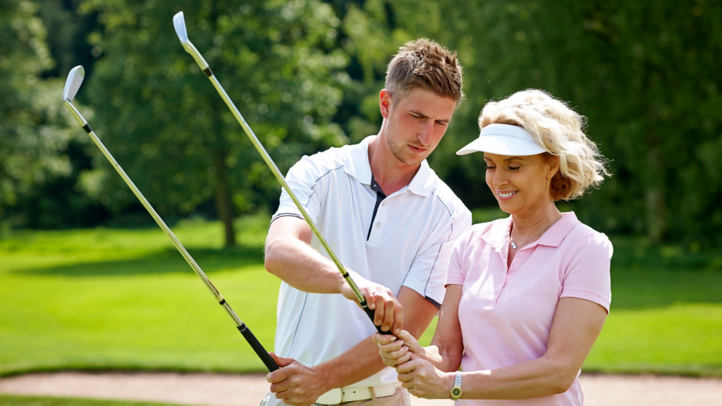 Golf instructor teaching student gripping on golf course