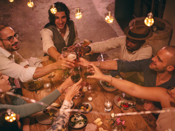 group of friends celebrating with drinks and appetizers
