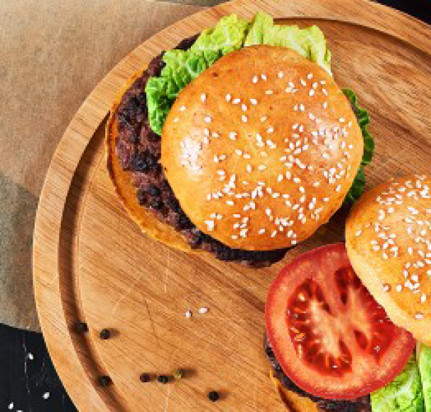 generic burger crafted on wood display plate
