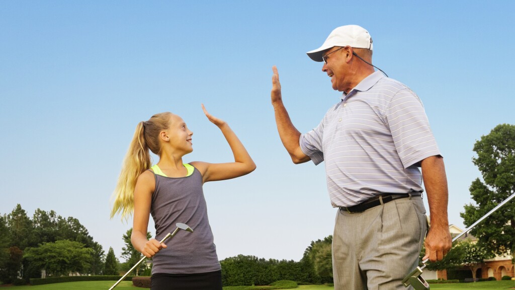 Family playing on golf course