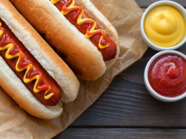 Barbecue Grilled Hot Dog with Yellow Mustard on wooden table