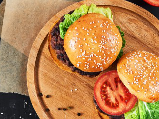 generic burger crafted on wood display plate